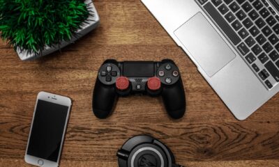 black game console on wooden surface